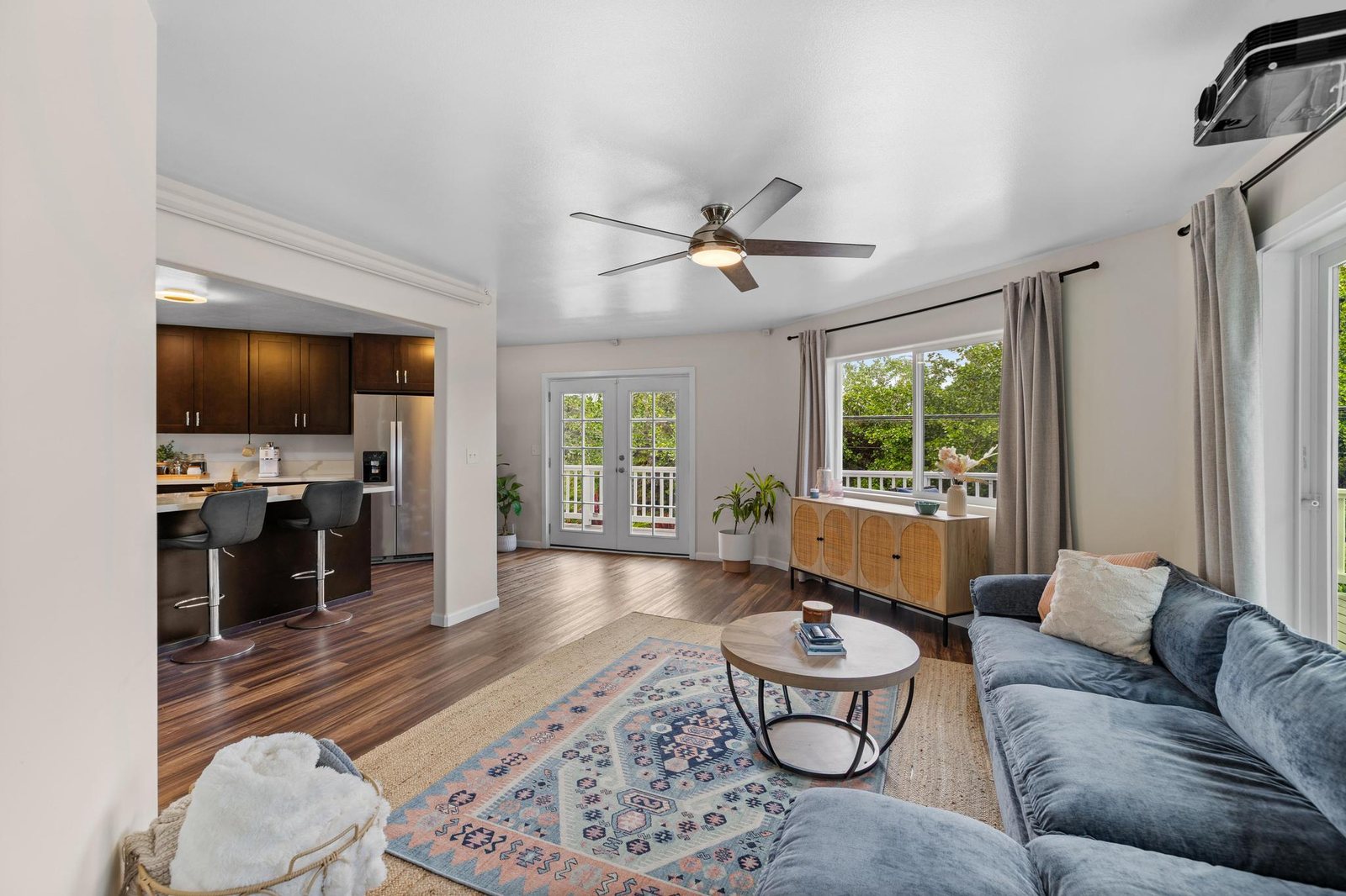 Family room opening to the kitchen, with French doors bringing in light from the lanai